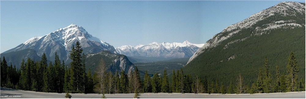 [ panoramic view of the mountains around banff as seen from the parking lot at the sulphur mountain gondola station ]